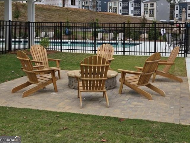 view of patio / terrace with a community pool and an outdoor fire pit