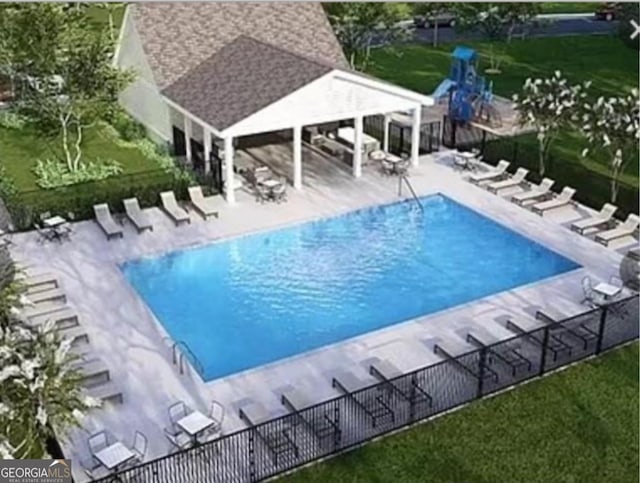 view of pool featuring a playground and a patio