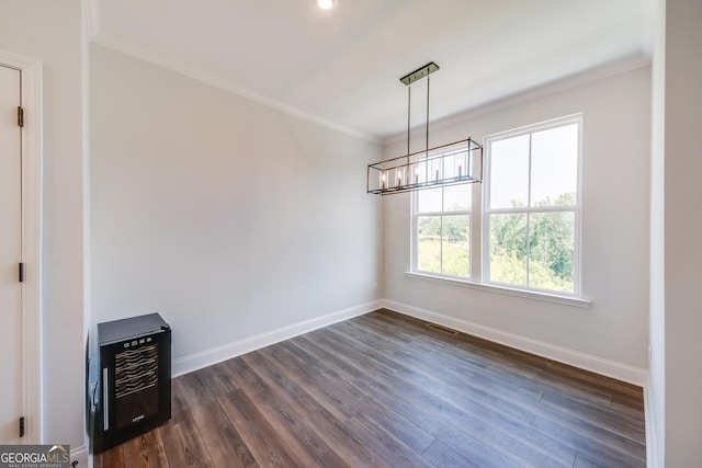 unfurnished dining area with crown molding, dark wood-type flooring, heating unit, and a notable chandelier