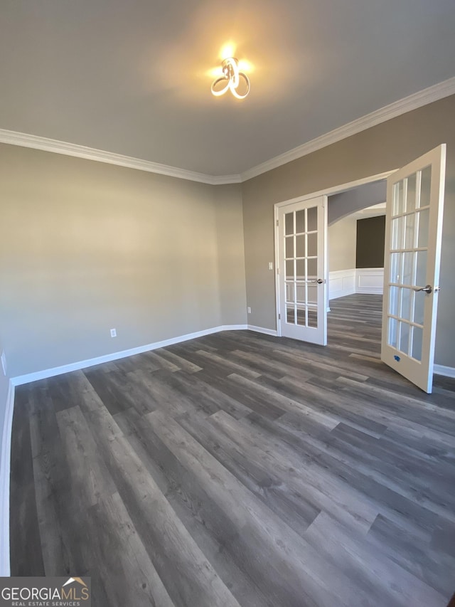 unfurnished room with french doors, crown molding, and dark hardwood / wood-style flooring