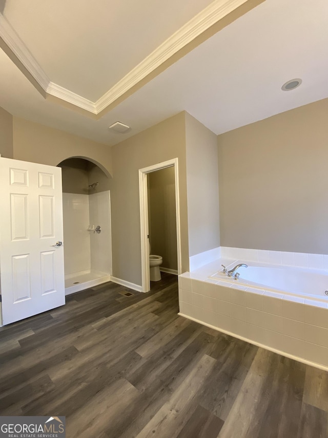 bathroom with toilet, wood-type flooring, ornamental molding, a tray ceiling, and plus walk in shower