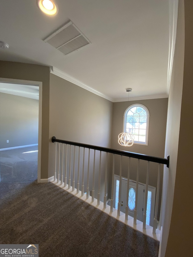 stairs featuring ornamental molding and carpet flooring