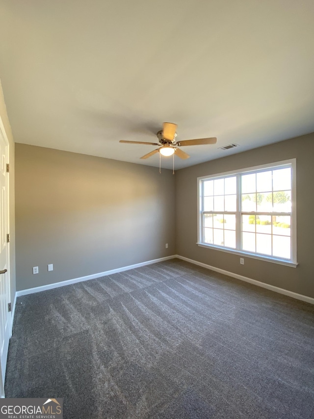 carpeted spare room with ceiling fan