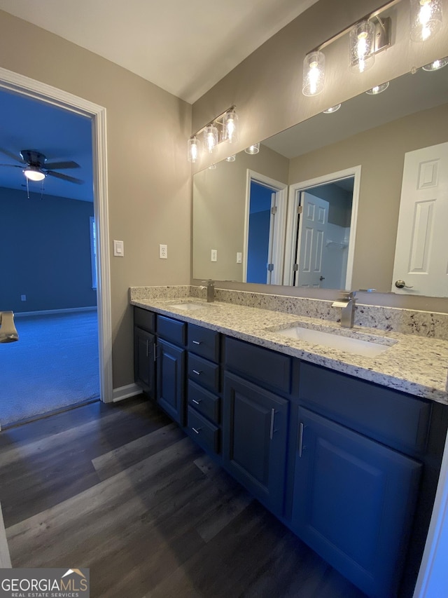 bathroom with ceiling fan, wood-type flooring, and vanity