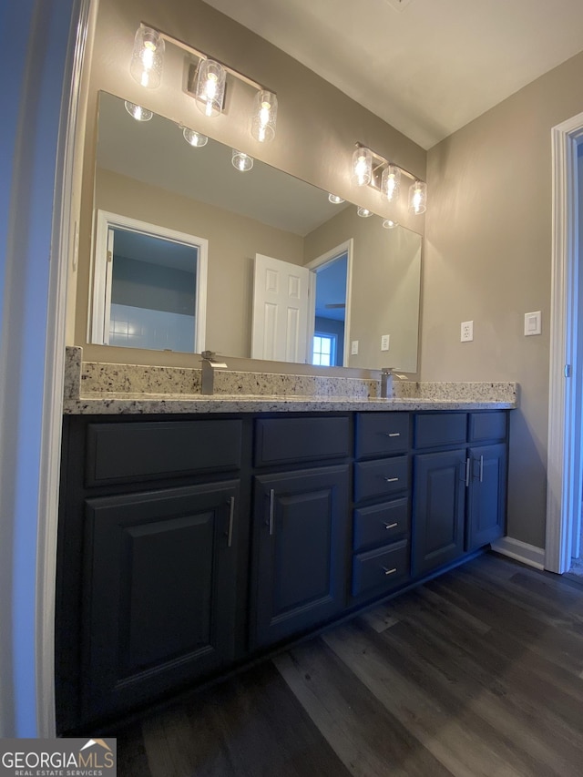 bathroom with vanity and wood-type flooring