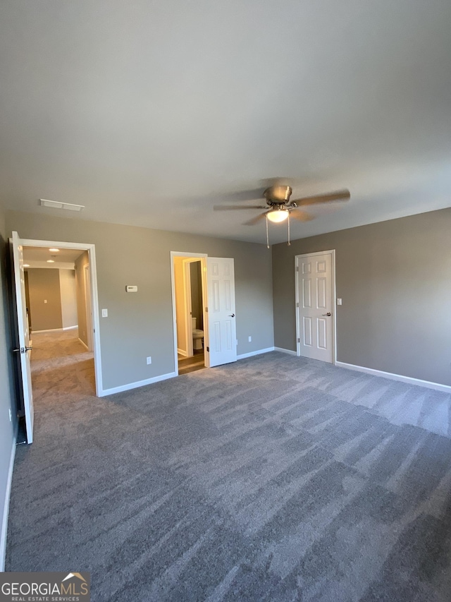 unfurnished bedroom featuring ceiling fan and carpet floors