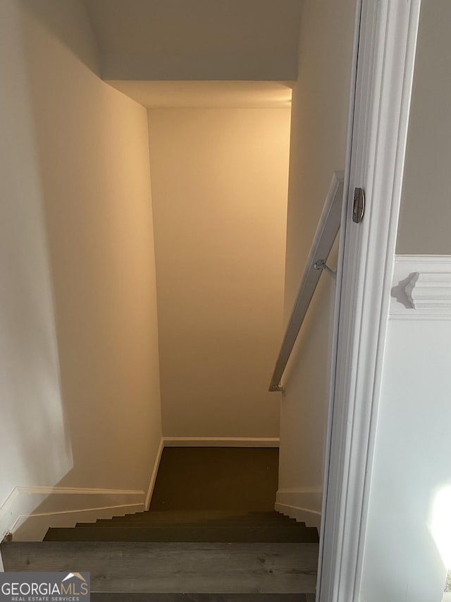 stairs featuring wood-type flooring