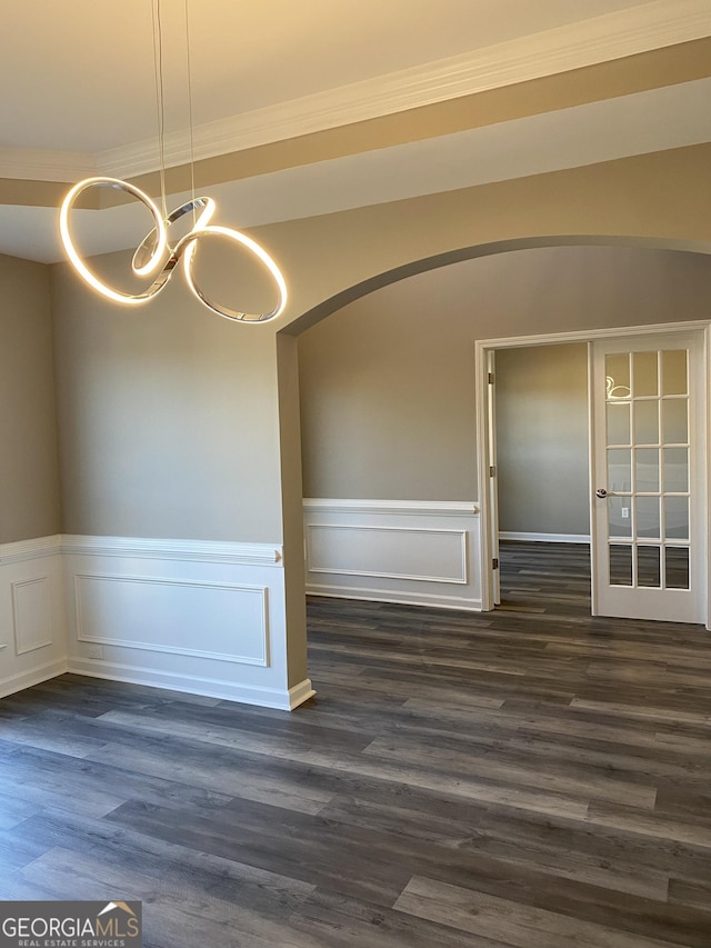 empty room featuring dark hardwood / wood-style floors and a chandelier