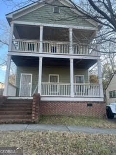 view of front of home with a balcony and covered porch