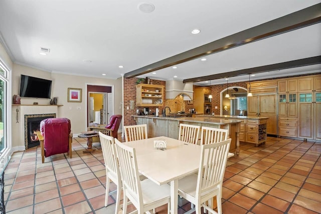 dining area with crown molding, light tile patterned floors, and beam ceiling