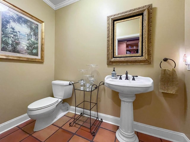 bathroom featuring ornamental molding, tile patterned floors, and toilet