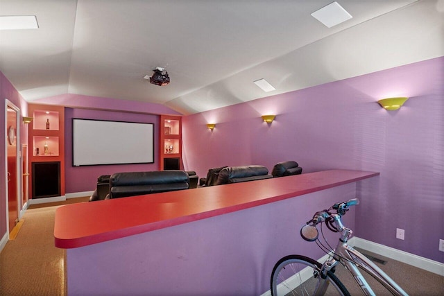 carpeted cinema room featuring lofted ceiling