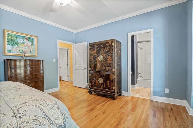 bedroom featuring hardwood / wood-style flooring, ornamental molding, ensuite bathroom, and ceiling fan