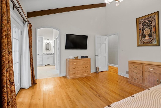 bedroom featuring ensuite bath and light hardwood / wood-style floors