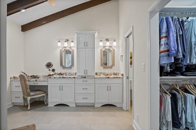 bathroom with vanity, vaulted ceiling with beams, and tile patterned floors