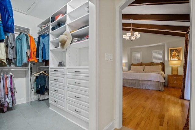 walk in closet featuring lofted ceiling and light hardwood / wood-style flooring