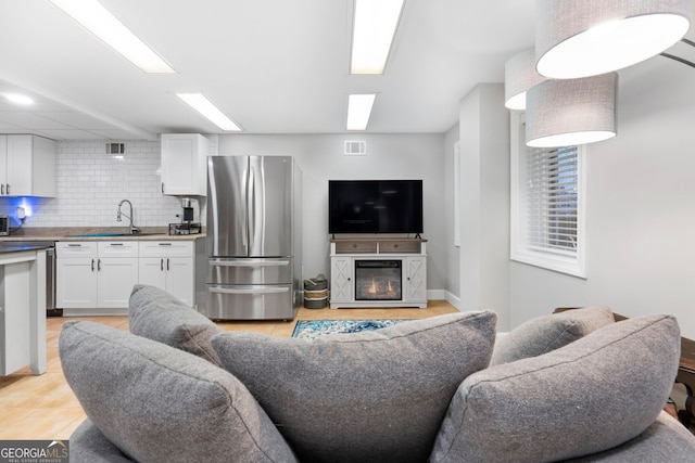 tiled living room featuring sink