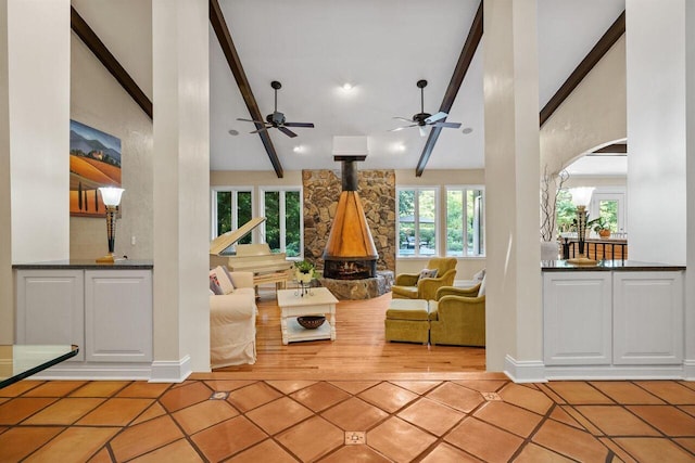 unfurnished living room featuring light tile patterned floors, beam ceiling, and high vaulted ceiling