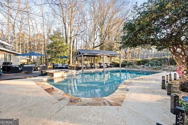 view of pool with a grill, a patio area, an outdoor structure, and an outdoor hangout area