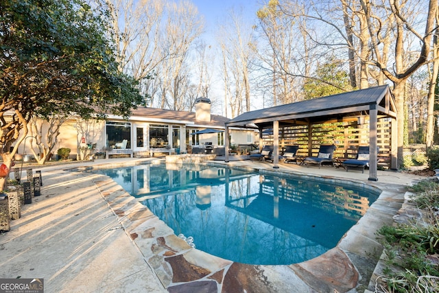 view of pool with an outdoor structure and a patio area