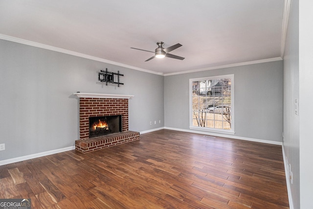 unfurnished living room with ceiling fan, a fireplace, dark hardwood / wood-style flooring, and crown molding