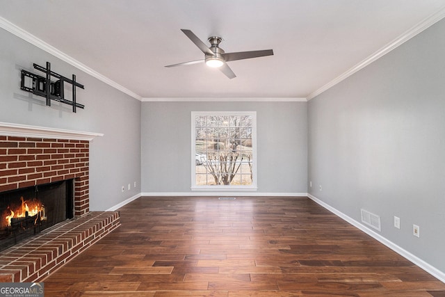 unfurnished living room with dark wood-type flooring, ceiling fan, a fireplace, and crown molding