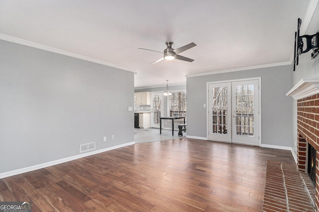 unfurnished living room with a brick fireplace, ornamental molding, dark hardwood / wood-style floors, and ceiling fan