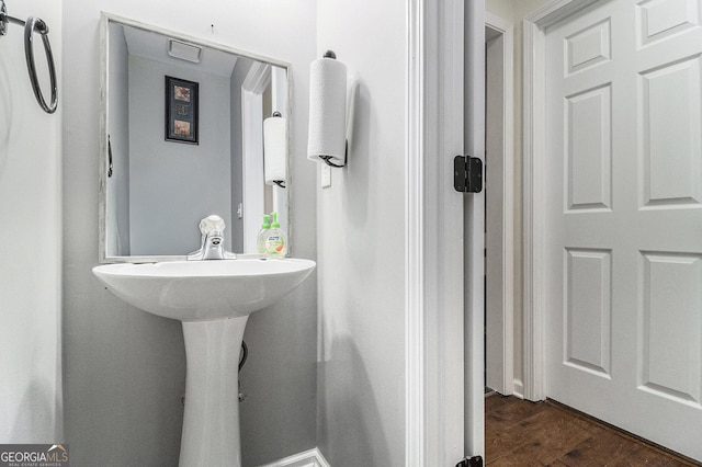 bathroom with hardwood / wood-style flooring