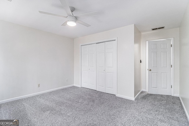 unfurnished bedroom featuring ceiling fan, carpet flooring, and a closet