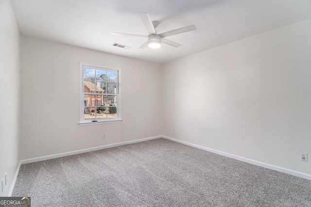 empty room featuring carpet floors and ceiling fan