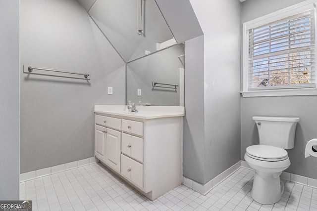 bathroom featuring tile patterned flooring, vanity, and toilet