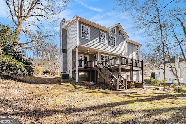 back of house with cooling unit and a wooden deck