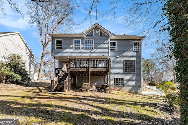 rear view of house with a yard and a deck