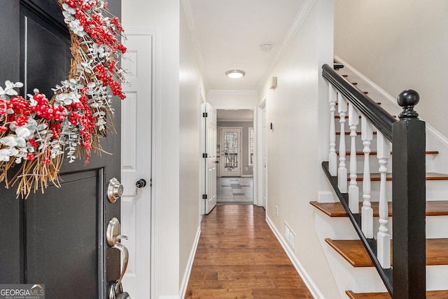 hall featuring dark wood-type flooring and ornamental molding