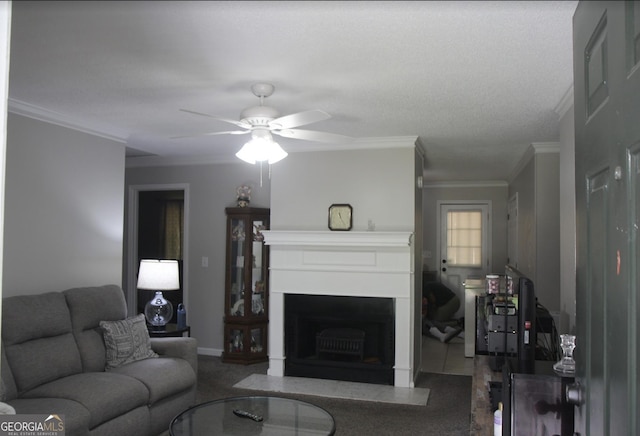 living room with ceiling fan and ornamental molding