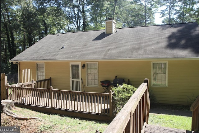 rear view of house featuring a deck