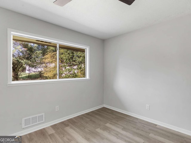 unfurnished room with ceiling fan and light wood-type flooring