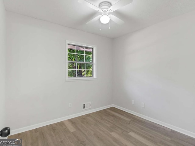 unfurnished room featuring hardwood / wood-style floors and ceiling fan