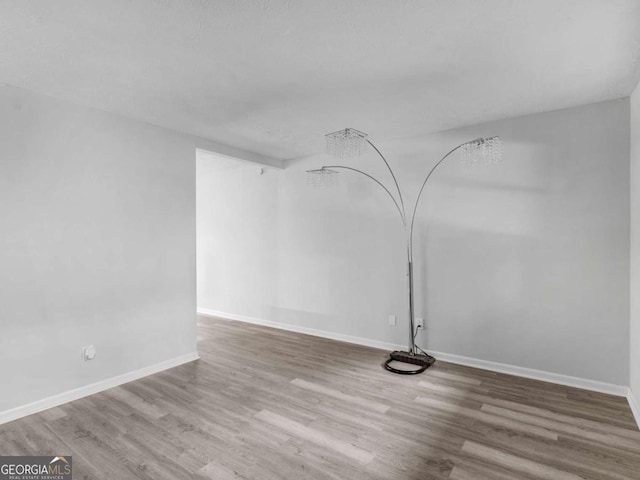 unfurnished room with hardwood / wood-style floors