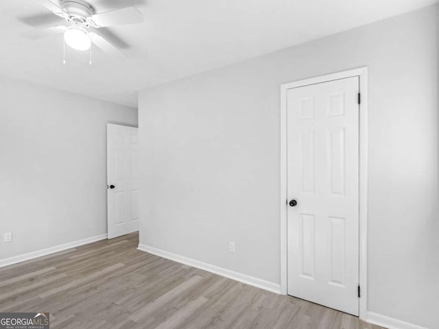 empty room with light hardwood / wood-style flooring and ceiling fan