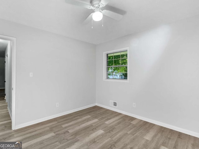 empty room with ceiling fan and light hardwood / wood-style floors