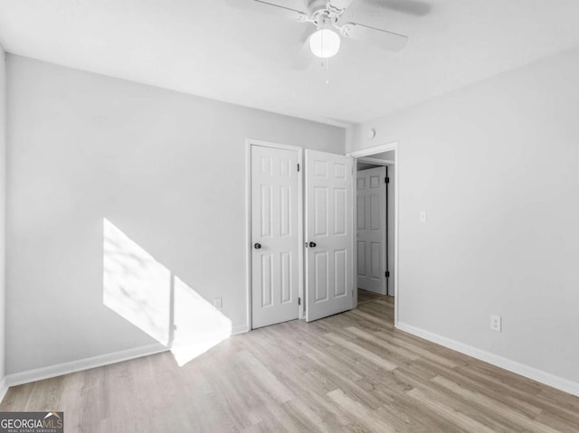 unfurnished room with ceiling fan and light wood-type flooring