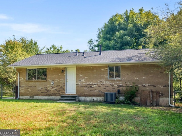 view of front of house with a front yard and cooling unit