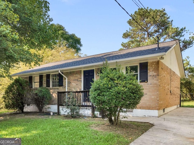 ranch-style house with covered porch and a front lawn