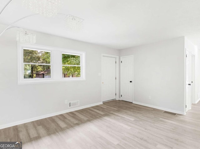 spare room with light hardwood / wood-style floors