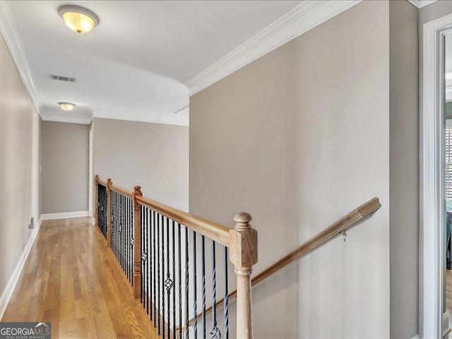 hall featuring ornamental molding and light wood-type flooring