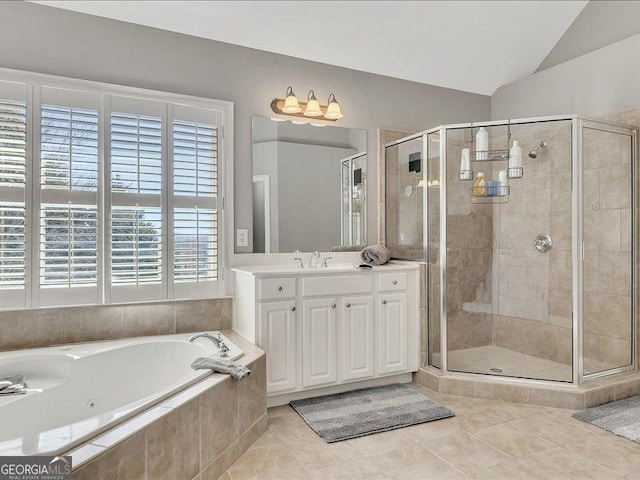 bathroom featuring vanity, tile patterned flooring, lofted ceiling, and independent shower and bath