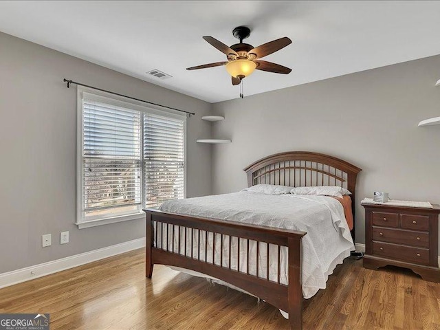 bedroom with hardwood / wood-style floors and ceiling fan