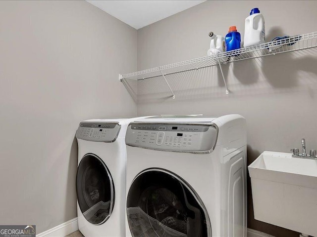 washroom featuring separate washer and dryer and sink