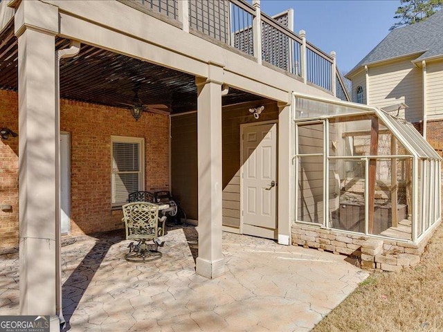 view of patio / terrace featuring a balcony and a sunroom